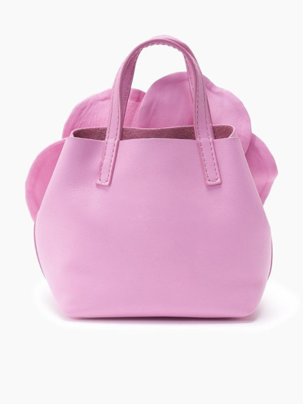 Pink leather handbag with floral accent, a versatile piece for stylish looks