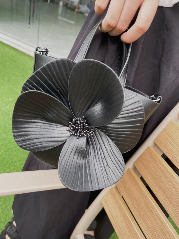 Black flower-adorned handbag showcasing a versatile piece for stylish crossbody wear