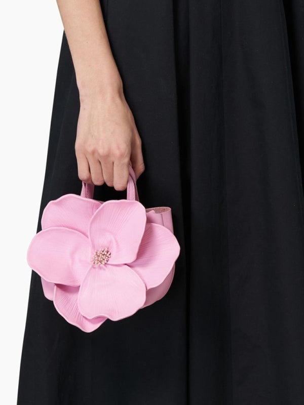 Pink flower-shaped handbag showcasing a versatile piece for stylish shoulder or crossbody wear