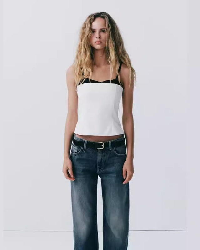 Woman in white tank top and jeans modeling the New Elegant and Sexy Lace Patchwork Bustier Top