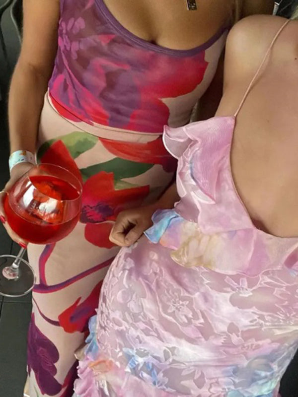 Two women in floral dresses showcasing the New Holiday Wavy Edge Suspender Dress
