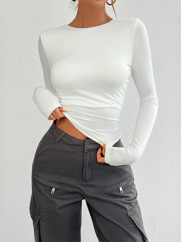 White long-sleeved crew neck knit top paired with gray cargo pants for a stylish look