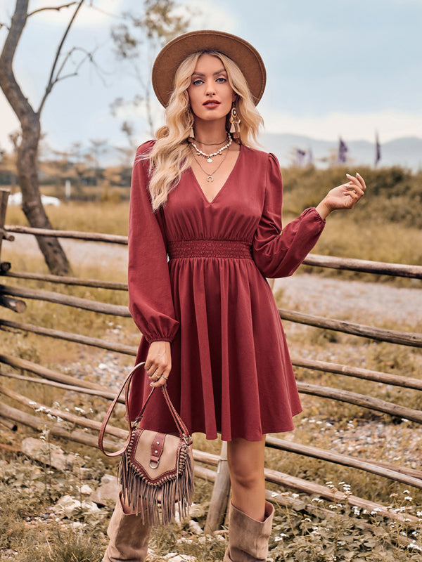 Woman wearing a maroon slim fit dress with stretch elastic waist and hat
