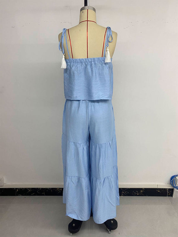 Light blue two-piece outfit featuring a suspender top and wide-leg trousers