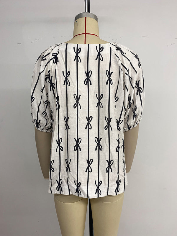 White blouse with black bow pattern from the Sweet and Simple Puff Sleeve Square Neck Bow Line Shirt collection