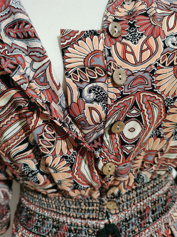 Patterned button-down blouse displayed in a Bohemian casual holiday beach dress