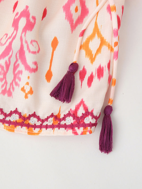 Patterned fabric with tassels and embroidered trim for V-neck camisole top with sequin embroidery