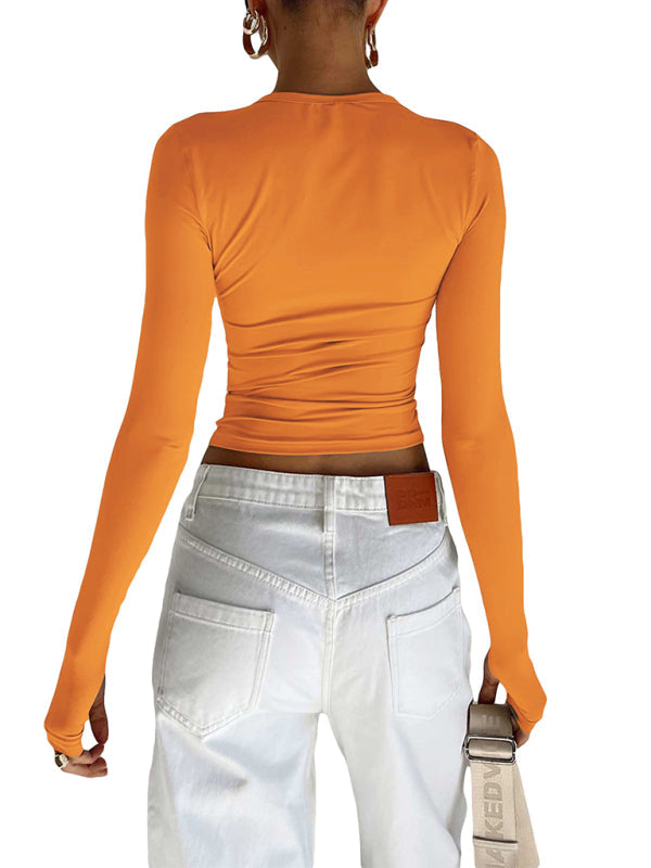 Orange long-sleeved solid color bottoming crop top with white jeans for women
