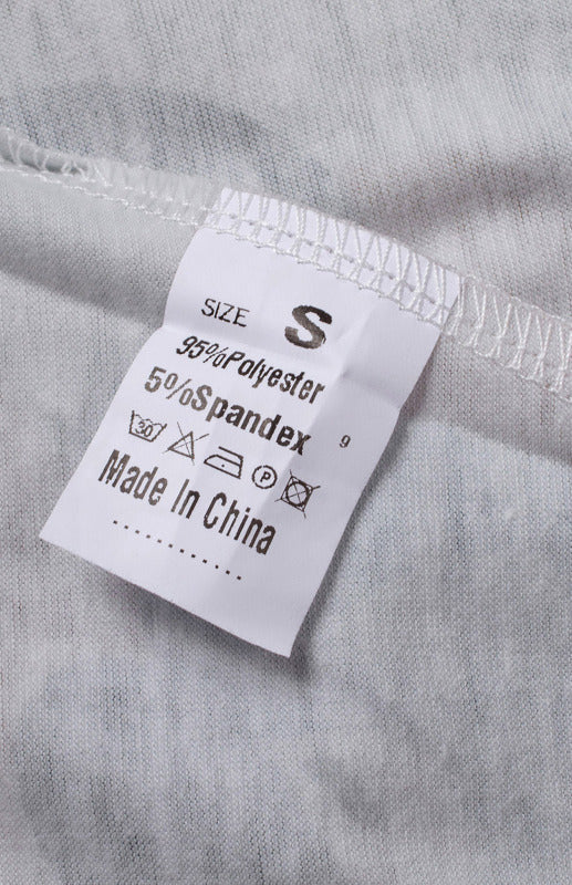 Clothing tag with size chart and material info for Women’s Striped Camo Crew Neck Top