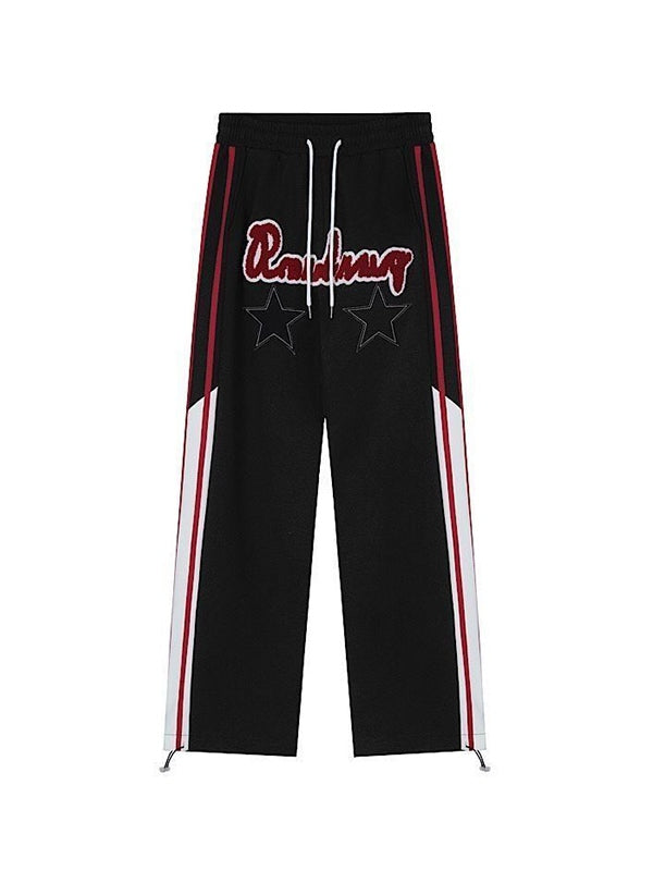 BLACK TRACK PANTS WITH STAR PATCH EMBELLISHMENT AND HIP POP STRIPES