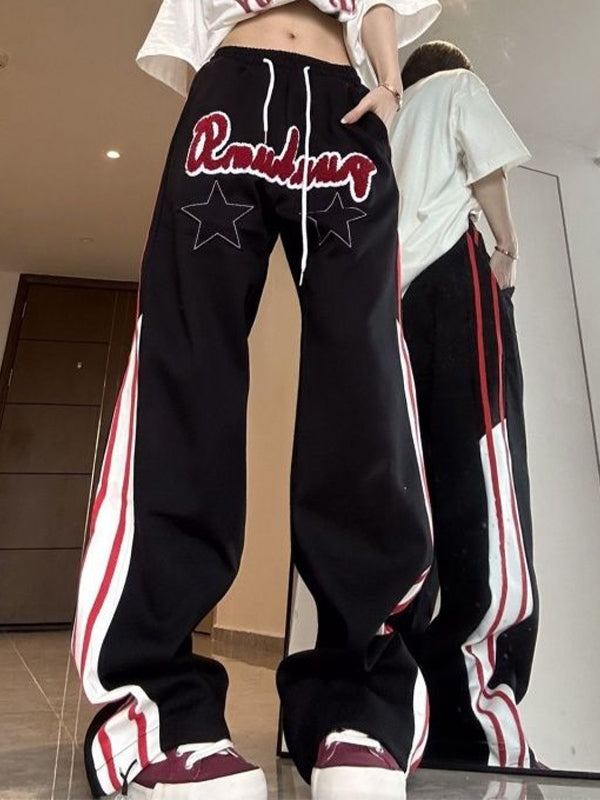 BLACK TRACK PANTS WITH STAR PATCH EMBELLISHMENT AND HIP POP STRIPES