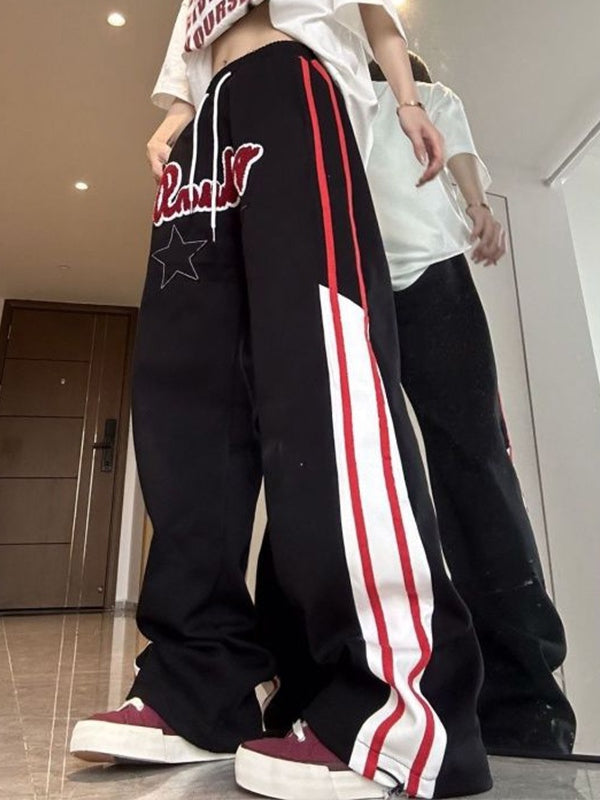 BLACK TRACK PANTS WITH STAR PATCH EMBELLISHMENT AND HIP POP STRIPES