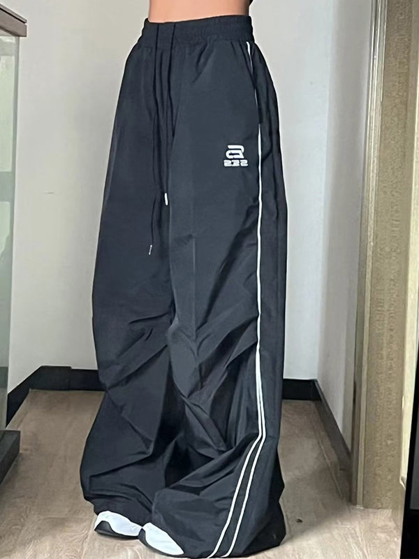 BLACK WIDE-LEGGED TRACK PANTS WITH DRAWSTRING WAIST AND LOOSE FIT