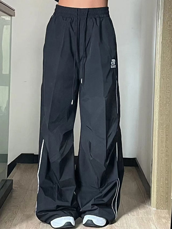 BLACK WIDE-LEGGED TRACK PANTS WITH DRAWSTRING WAIST AND LOOSE FIT