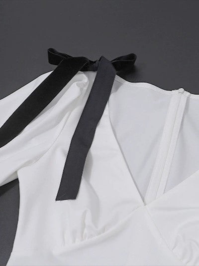 ELEGANT WHITE DRESS WITH BLACK RIBBON ACCENTS AND ROMANTIC PUFF SLEEVES
