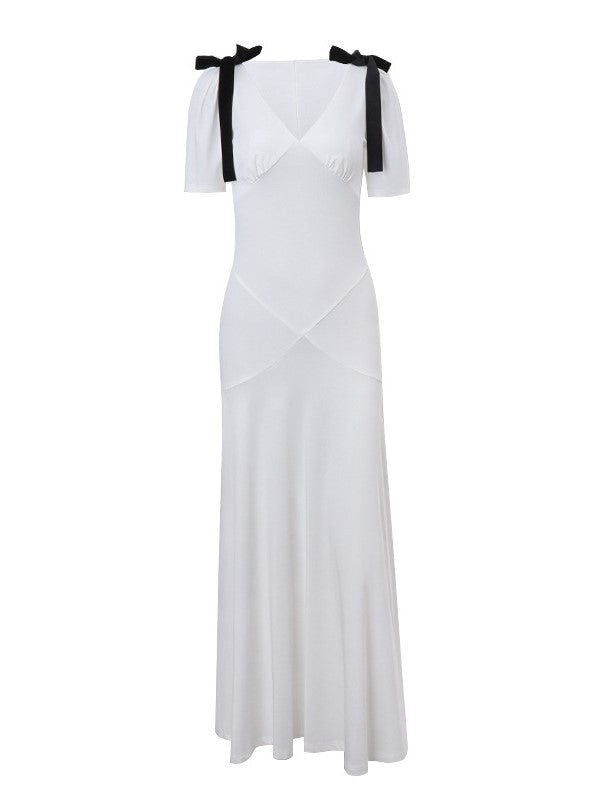 ELEGANT WHITE DRESS WITH BLACK RIBBON ACCENTS AND ROMANTIC PUFF SLEEVES
