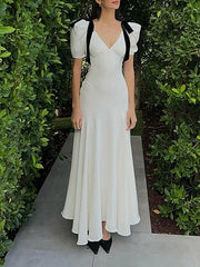 ELEGANT WHITE DRESS WITH BLACK RIBBON ACCENTS AND ROMANTIC PUFF SLEEVES