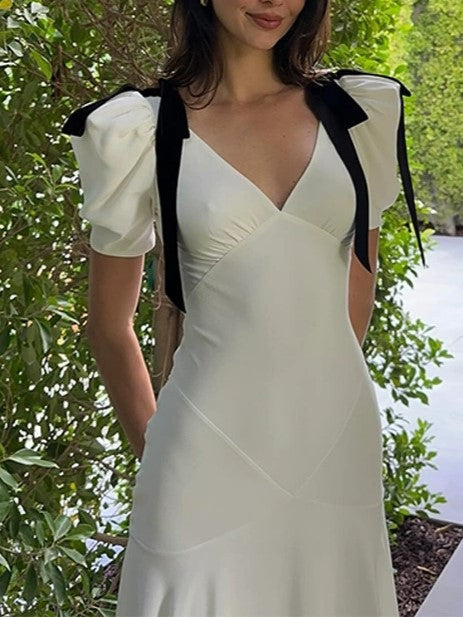 ELEGANT WHITE DRESS WITH BLACK RIBBON ACCENTS AND ROMANTIC PUFF SLEEVES