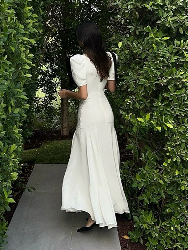 ELEGANT WHITE DRESS WITH BLACK RIBBON ACCENTS AND ROMANTIC PUFF SLEEVES