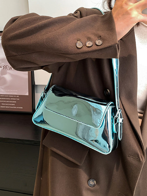 Modische Damen-Schultertasche aus Lackleder mit Baguette-Struktur und glänzendem Finish, die unter dem Arm getragen wird 