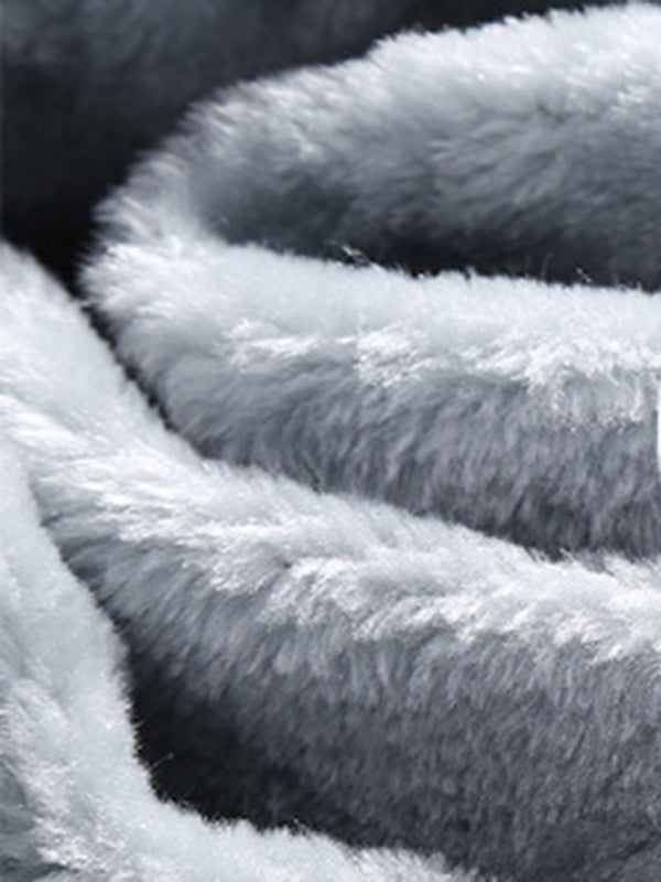 Close-up view of soft, plush grey polyester fabric showing its fluffy texture.