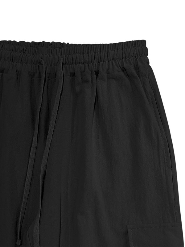 Pantalon ample à cordon de serrage, couleur unie, ourlets décontractés et poches multiples. 