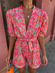 Multicolor printed jumpsuit with deep V-neckline and bubble sleeves – front view