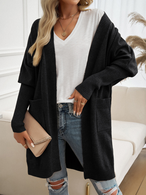 Batwing Sleeve Cardigan Solid Color Sweater Jacket in black, worn by a woman with a white V-neck top and ripped jeans, holding a beige clutch.