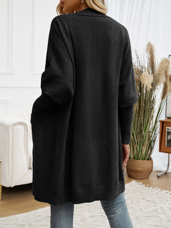 Back view of a person wearing a black Batwing Sleeve Cardigan Solid Color Sweater Jacket.