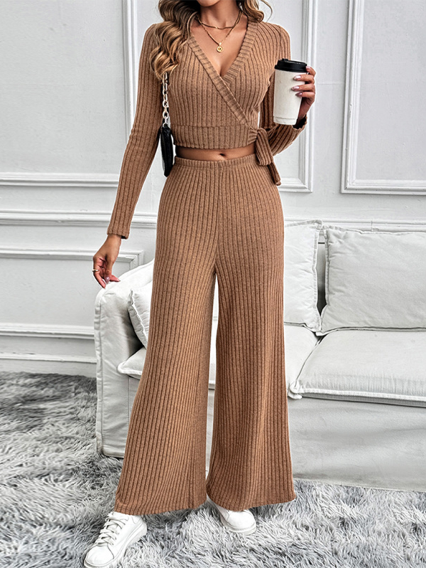 Autumn and winter long-sleeved suit solid color texture basic versatile ladies two-piece suit in beige worn by a woman holding a coffee cup.