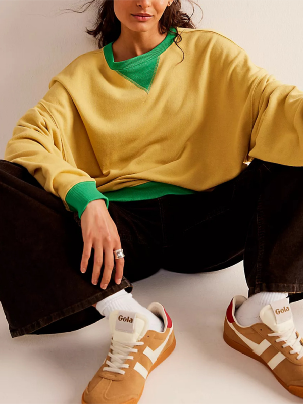 Person wearing yellow and green solid color round neck loose sweatshirt with brown sneakers