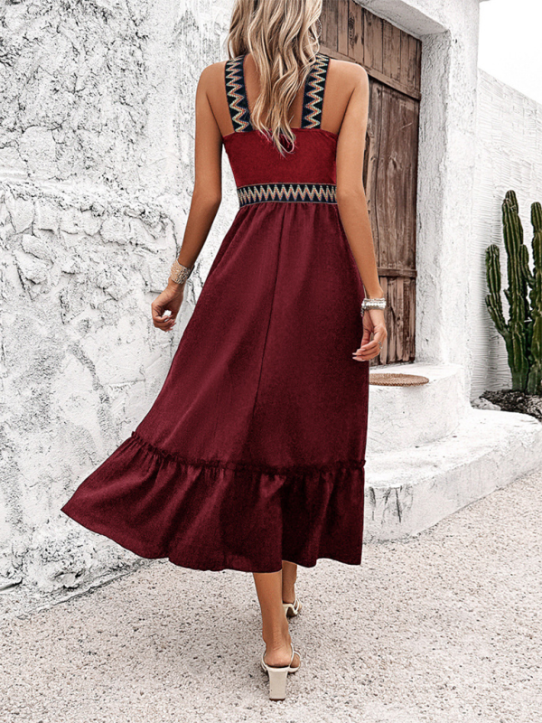 Maroon midi dress with patterned straps and high waist, featuring a halter neck design