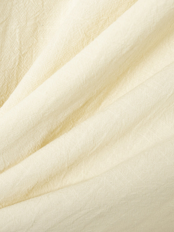 Wrinkled light-yellow fabric showcasing collar slim design for casual long sleeve shirt