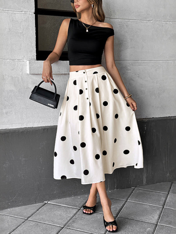 Woman wearing a black crop top and polka dot umbrella skirt in a retro elegant style