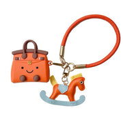 ORANGE ROCKING HORSE HANDBAG AIRPODS CASE