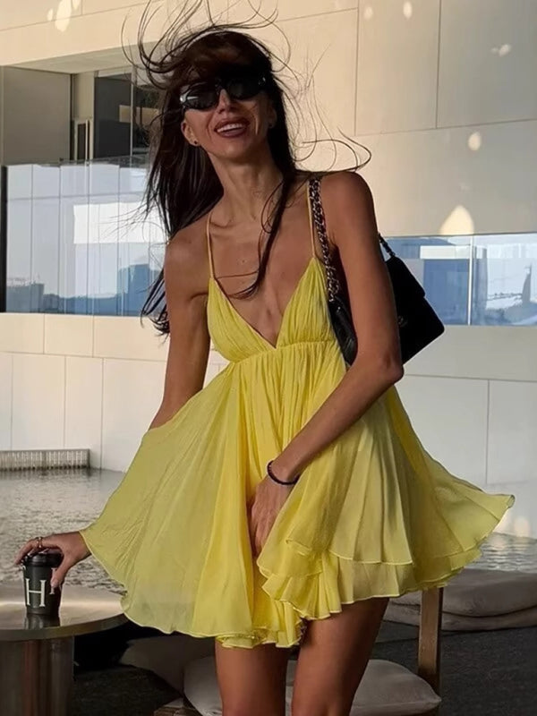 Yellow pleated mini dress with V-neck and halter back design for stylish holidays