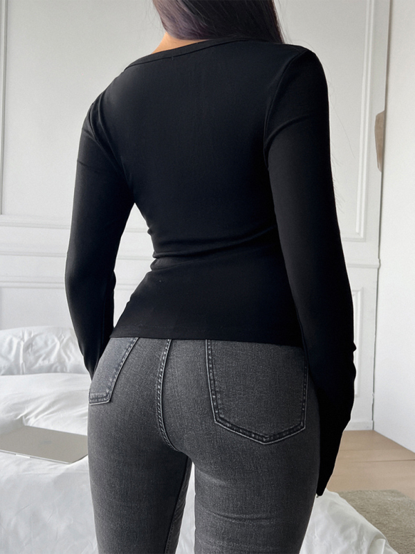 Black long-sleeved V-neck button-up T-shirt paired with gray jeans for a stylish look