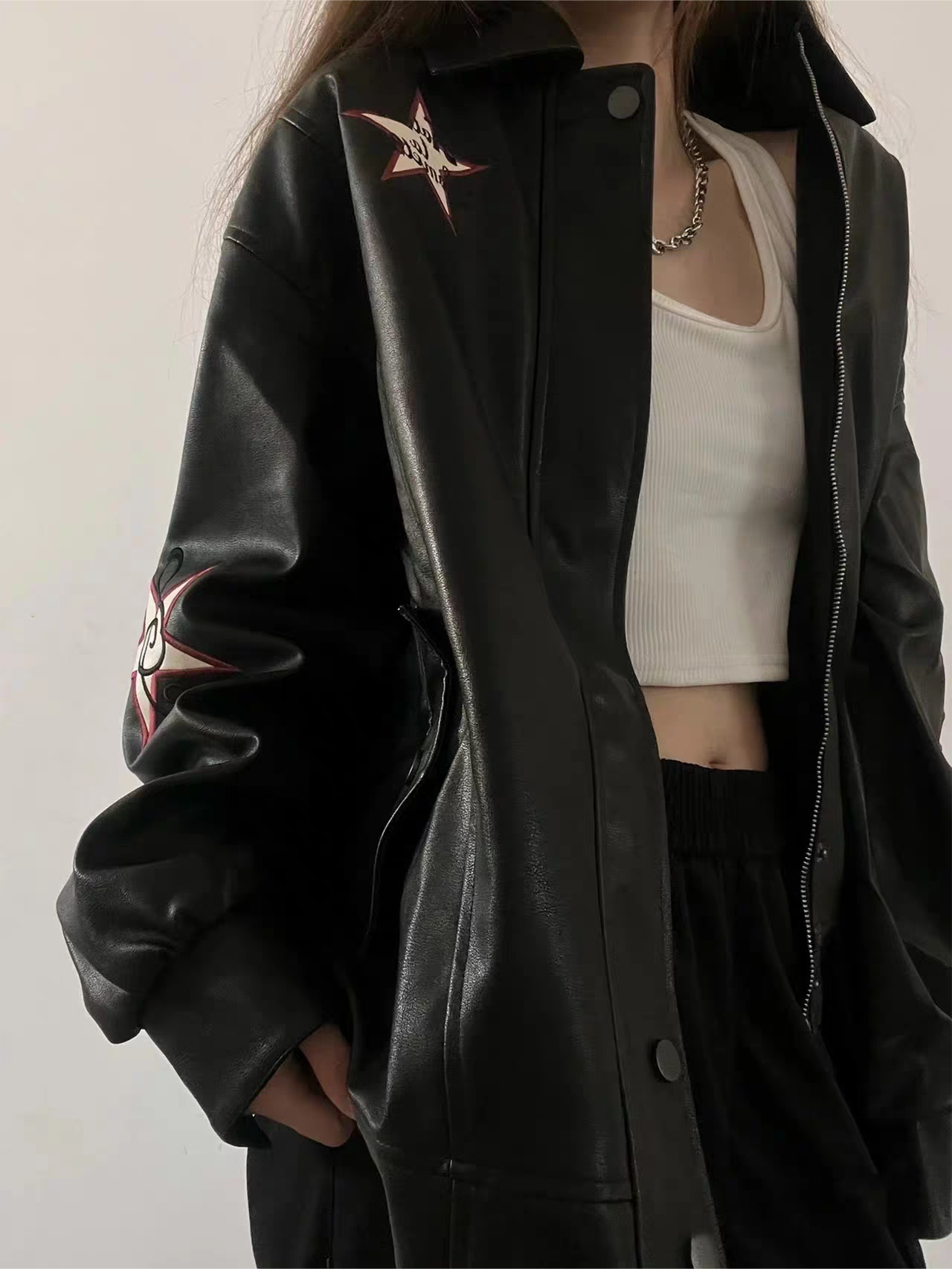 VERSATILE BLACK LEATHER JACKET WITH STAR EMBELLISHMENTS
