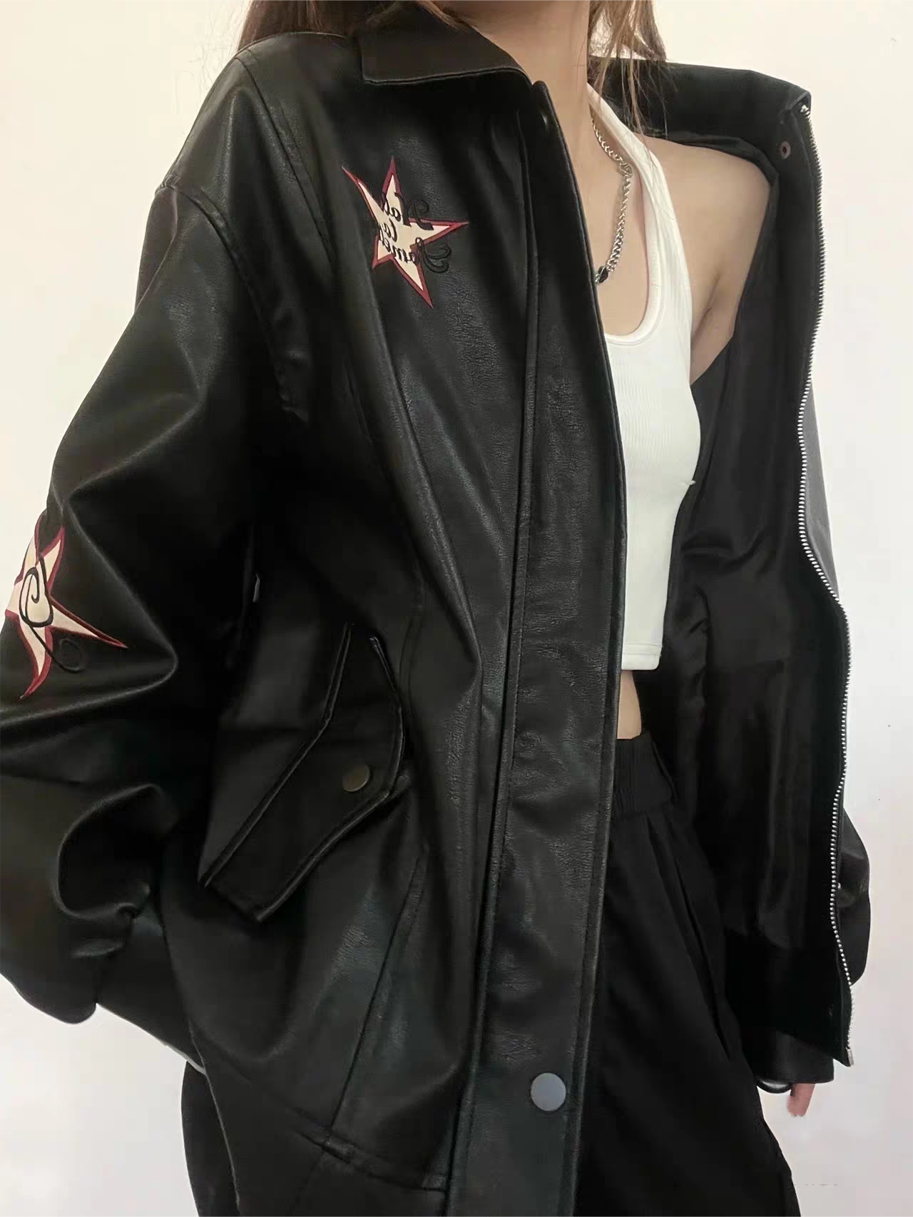 VERSATILE BLACK LEATHER JACKET WITH STAR EMBELLISHMENTS