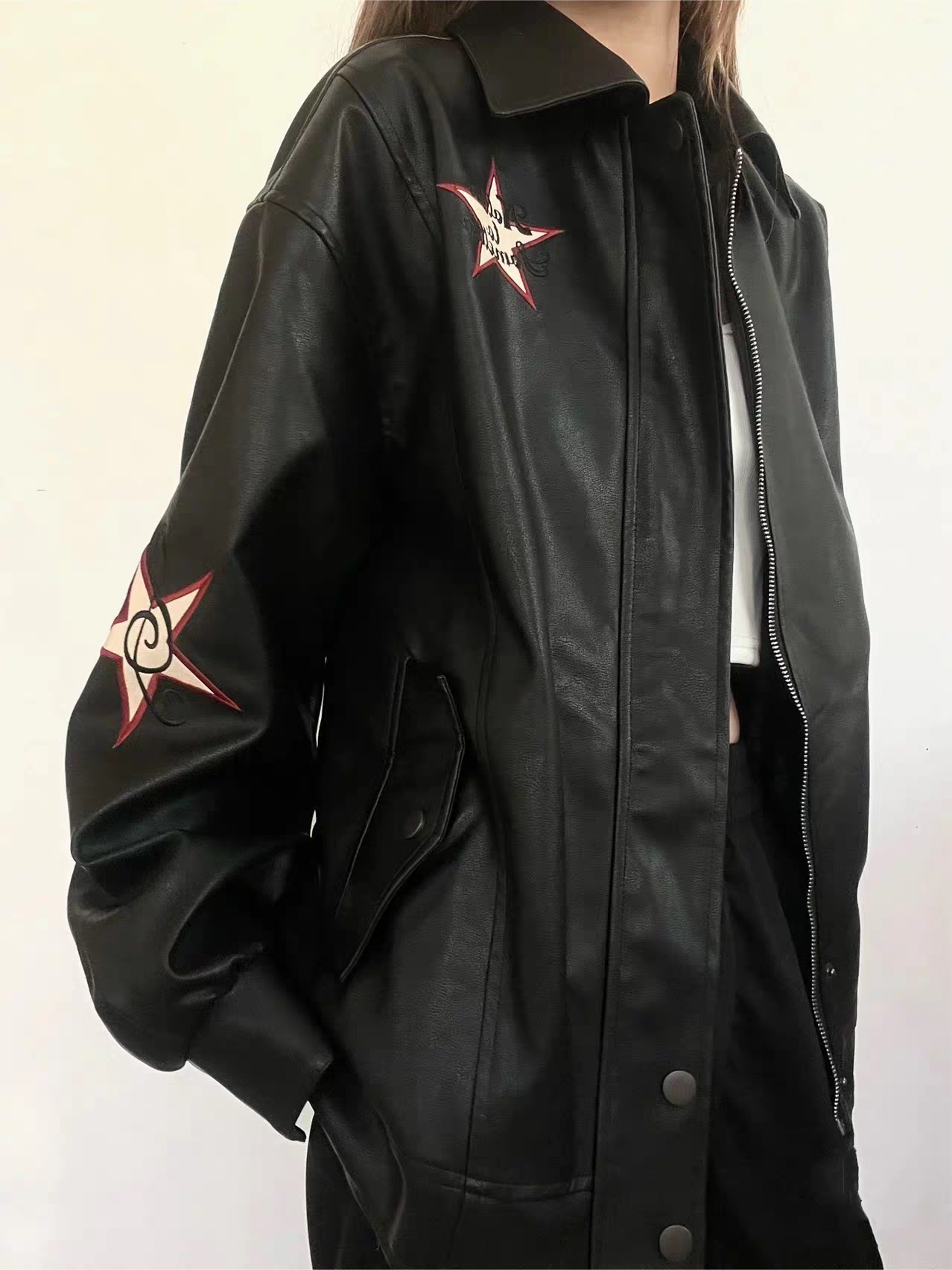 VERSATILE BLACK LEATHER JACKET WITH STAR EMBELLISHMENTS