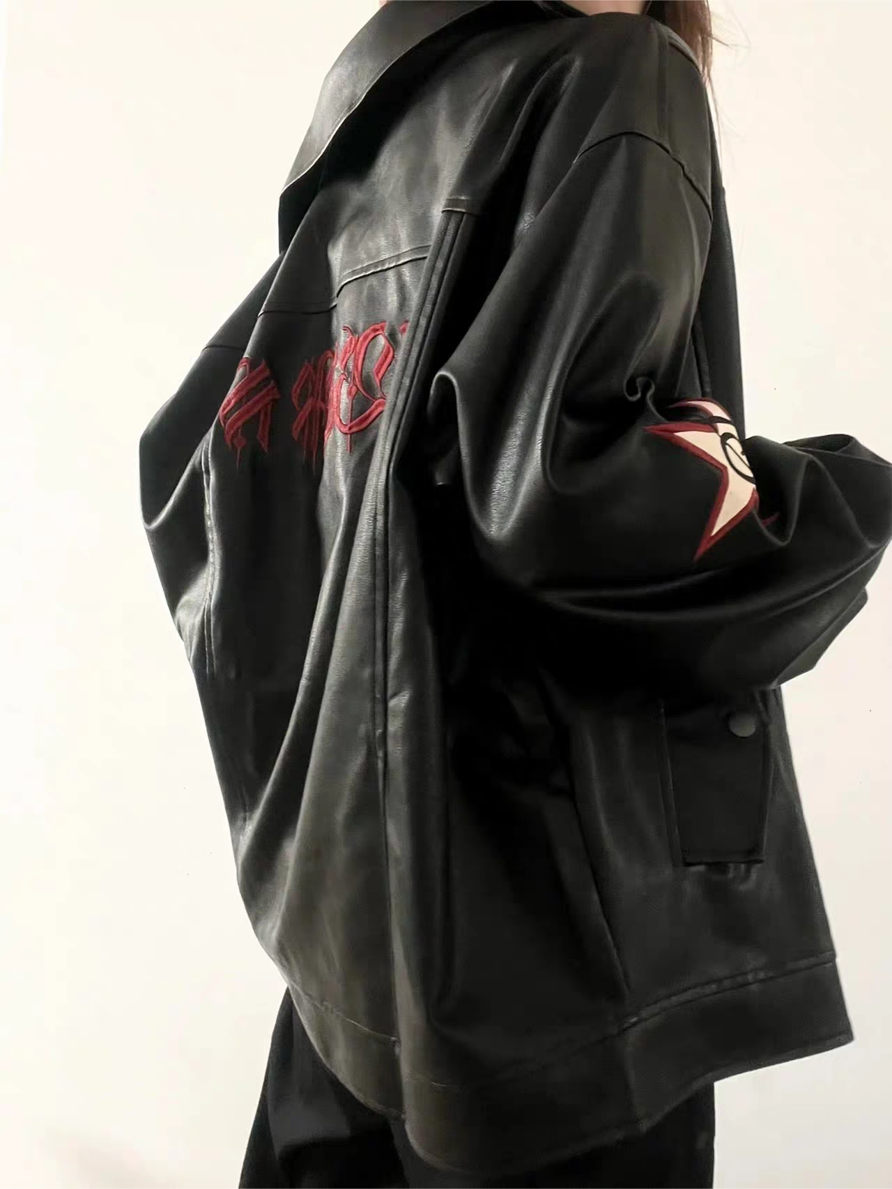 VERSATILE BLACK LEATHER JACKET WITH STAR EMBELLISHMENTS