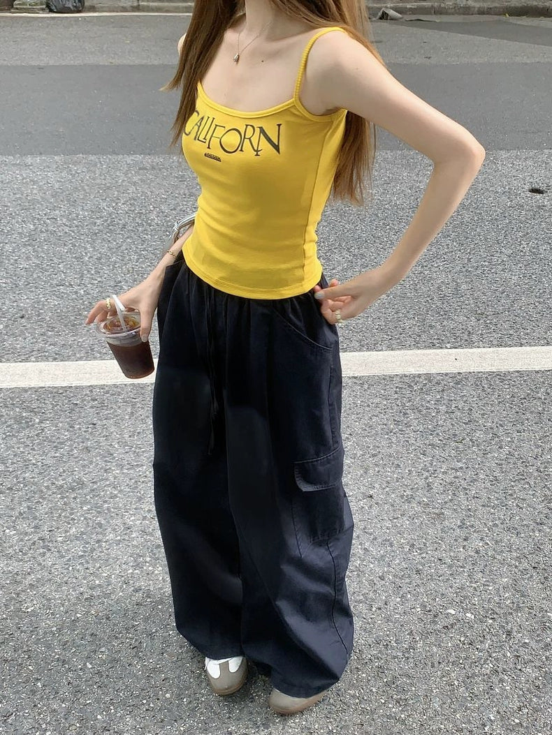 VIBRANT YELLOW CAMI AND BLACK CARGO PANTS SET WITH BOLD LETTER PRINT