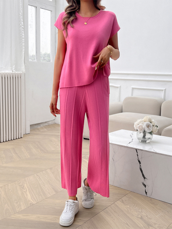 Woman wearing a pink knit sweater set from the Women’s casual solid color sweater set collection