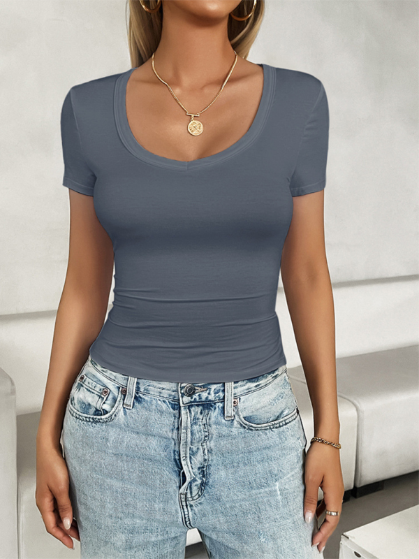 Woman in gray casual U-neck slim fit solid color T-shirt showcasing leisure style fashion