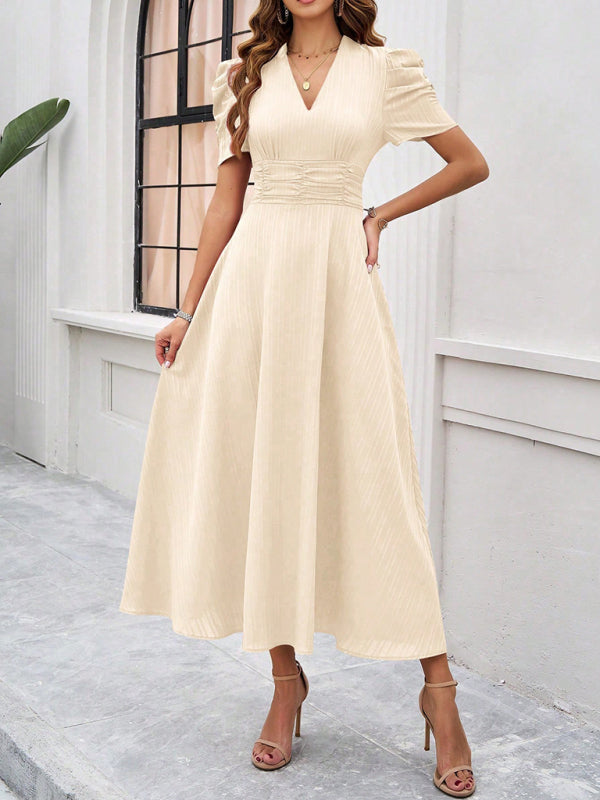 Cream-colored midi dress showcasing elegant solid color waist design for women
