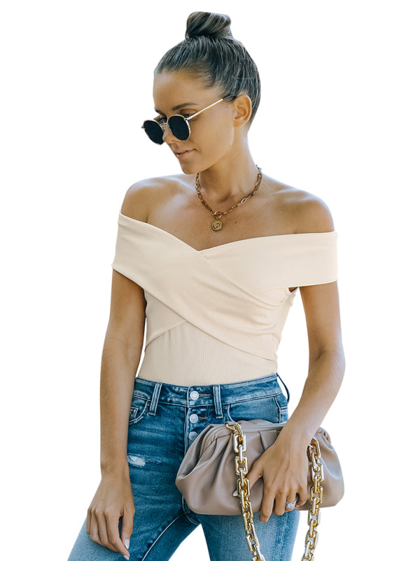 Woman wearing a beige fashion skinny off-shoulder top with slight elasticity and jeans